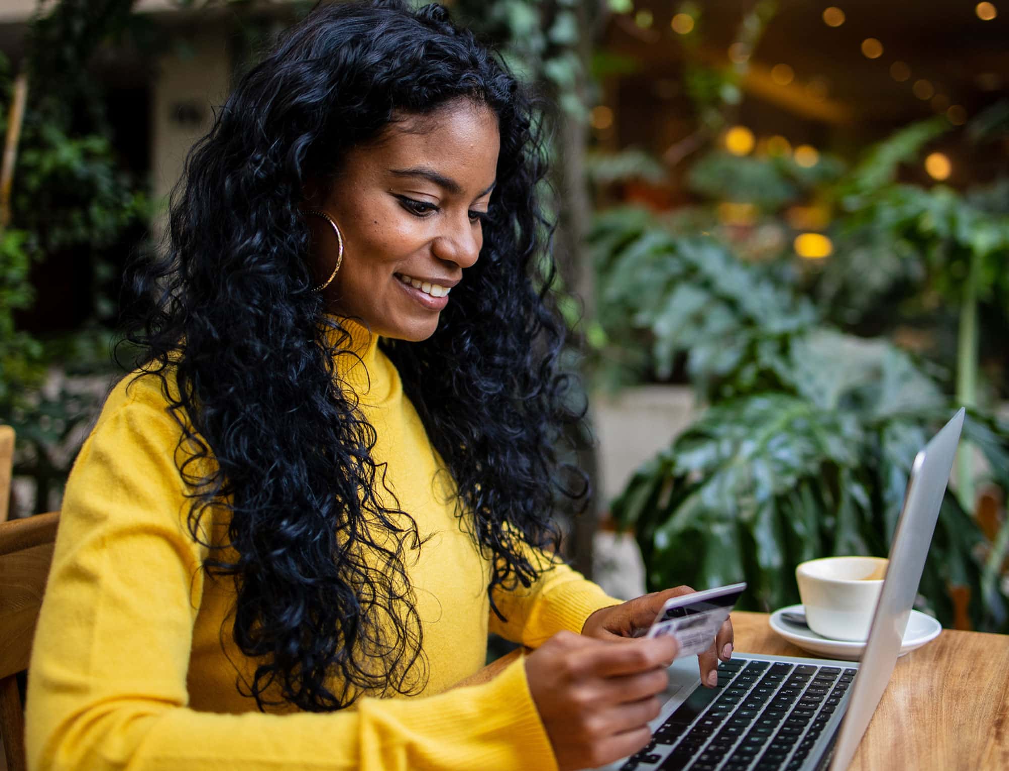 a woman sitting at a table using a laptop