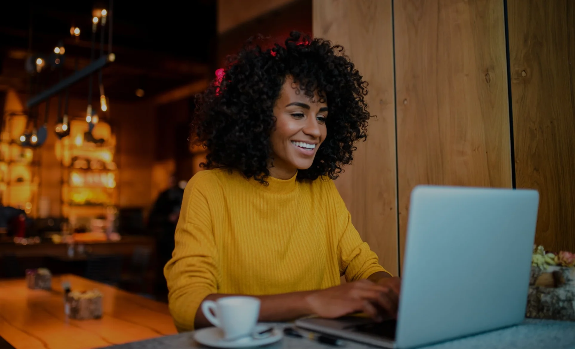 a person sitting at a table using a laptop